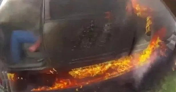 Zamanla yarış kamerada! ABD’de polisler, yanan aracın camını kırarak sürücüyü son anda kurtardı