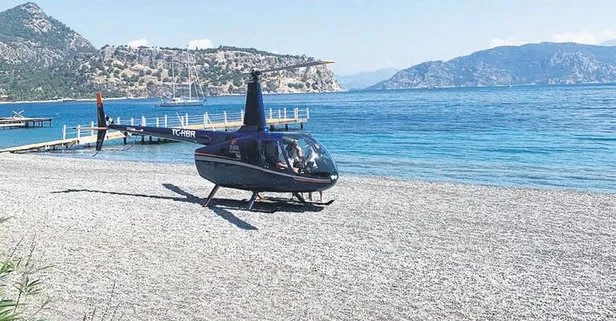 VAV Teknoloji sahibi Temel Akçay, eşiyle helikopterine atladı! Marmaris’teki halk plajına iniş yaptı