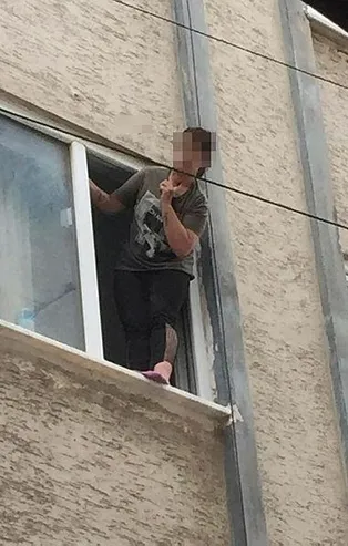 Çıktığı pencerede, boğazına bıçak dayayıp intihara kalkıştı