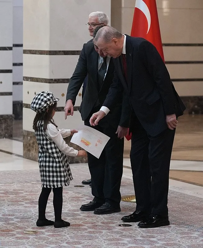 baskan-erdogan-5-ulkenin-buyukelcisini-kabul-etti-1762261097082.jpg Lübnan Büyükelçisi Anuti'nin küçük kızı, Erdoğan'a çizdiği resmi hediye etti. (AA)