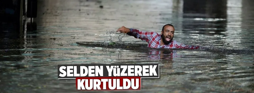 Sel sularından yüzerek kurtuldu